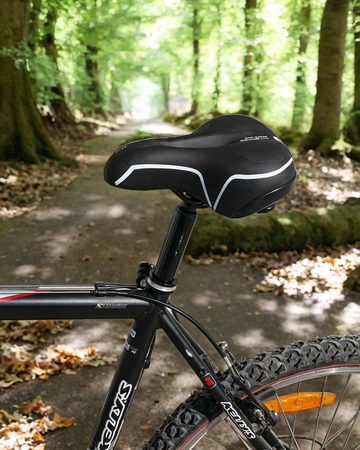 Siodełko rowerowe szerokie amortyzujące z odblaskami RS7 białe